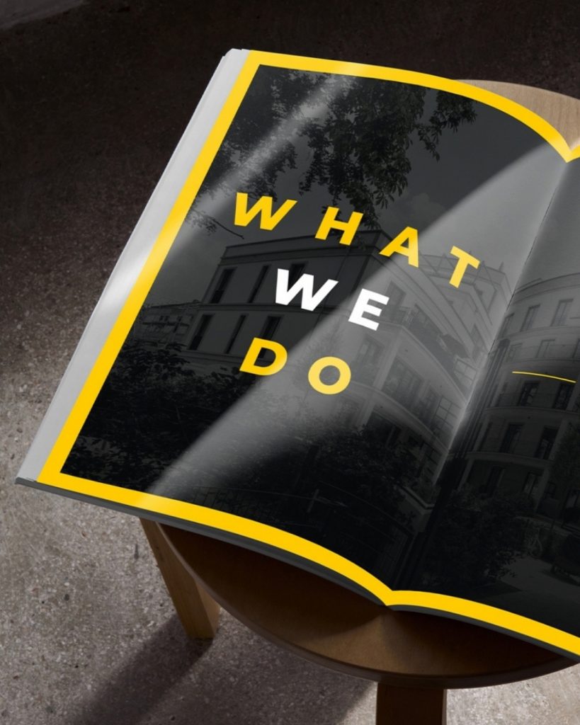 Eine Broschüre der NexiHome AG. Die linke Seite der Broschüre zeigt "What We Do" in großer Schrift, hinterlegt mit einem ausgegrauten Bild eines Smart Homes.